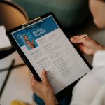 Person Holding Black Ipad With Black Case